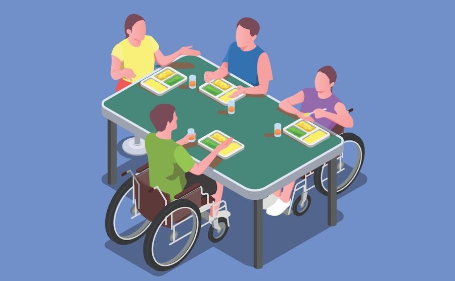 Menschen mit und ohne Behinderung sitzen gemeinsam an einem Tisch und spielen Gesellschaftsspiele